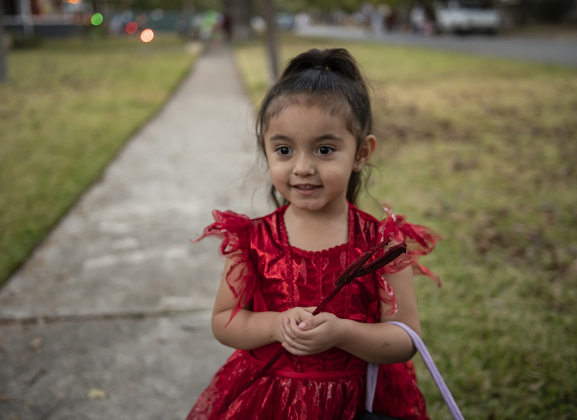 2-year-old Zayla Hernandez was a devil in her bright red dress and pitchfork during  Halloween night along Main Street  on Thursday, October 31, 2024.   Photo by Andy Sharp.