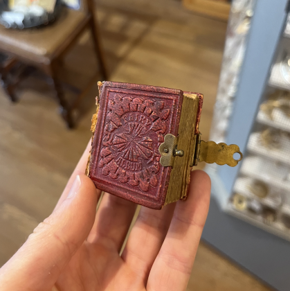 Ms. Martin’s favorite item currently in the store is a Fairy Album. It is a miniature photo album from the 1800s with portraits. Photo by Abbey Archer