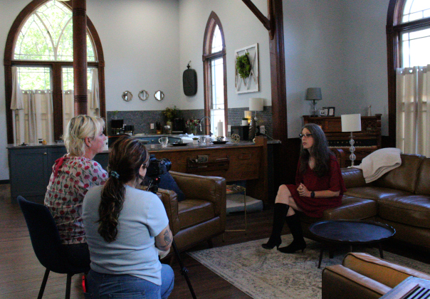 Producer Roxane Davis, left, interviews Bartlett resident Jennifer Tucker, right, about the history of Bartlett in Ms. Tucker’s home. The building was a former church until Ms. Tucker bought it and renovated it to be an Airbnb. Photo by Nalani Nuylan.