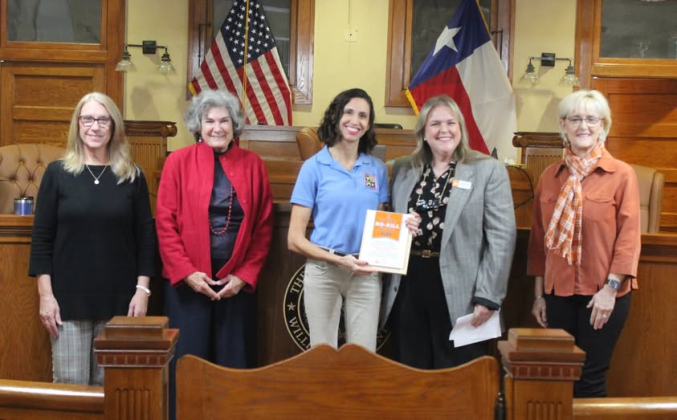 Williamson County Regional Animal Shelter Director Misty Valenta, center, with Kasey Spain, senior manager of Best Friends Network, right, presents a “No-Kill” plaque to the Williamson County Commissioners during the November 26 meeting. Commissioners in attendance from left to right are Cynthia Long, Terry Cook, and Valerie Covey, far left. Photo courtesy of Williamson County.  