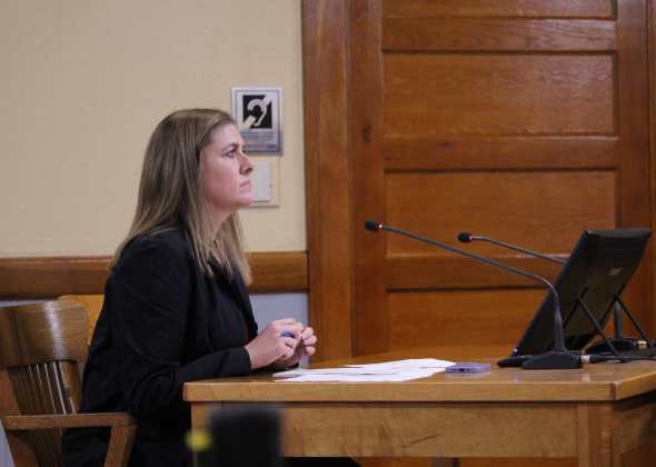 County Manager Rebecca Clemons answers questions about the proposed Death Investigator salaries during the December 10 Commissioners Court meeting. Photo by Nalani Nuylan.