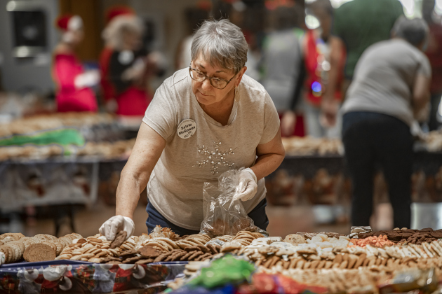 Sun City resident Sylvia McGowan helps prepare 500 dozen homemade cookies for the Women Helping Others (WHO) distribution on Monday, December 23, 2024.