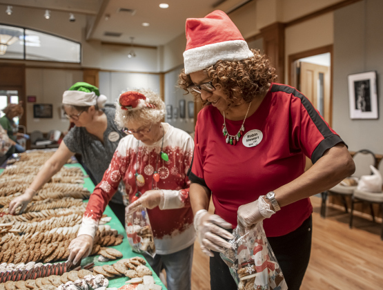 Robin Stewart (front) was one of the volunteers helping prepare 500 dozen homemade cookies in Sun City  for the Women Helping Others (WHO) distribution on Monday, December 23, 2024.