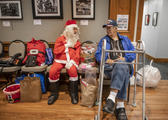 Sun City residents Gil Douglas (as Santa Claus) and Frank B. Rankin take time to visit.