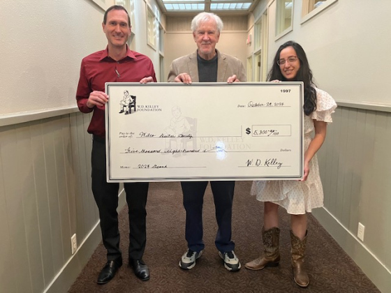 Carl Illig, Kevin Taylor and Gabriela Bravo stand with a check supporting the Wilco Guitar Society. (Photo courtesy Wilco Guitar Society)