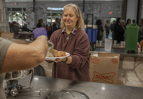Lisa Pierce is assisted with her meal during the Community Thanksgiving, held Thursday, November 28, 2024 at the San Gabriel Community Center in San Gabriel Park.