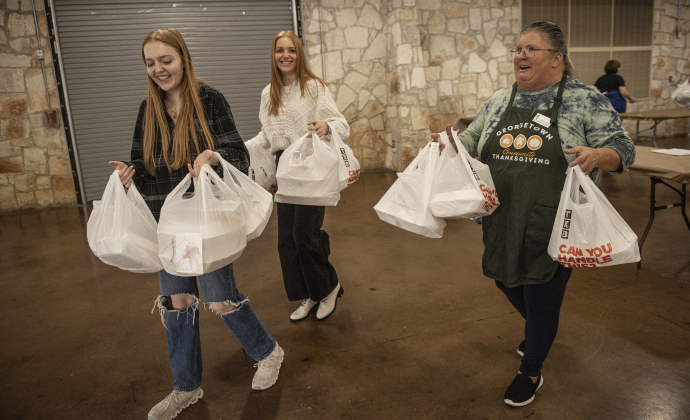 Ashlynne Grasse, 18, left, her sister Raelyn, 15, center, are joined by Alycia Tandy as they help deliver meals to home-bound diners during the Community Thanksgiving, held Thursday, November 28, 2024 at the San Gabriel Community Center in San Gabriel Park.