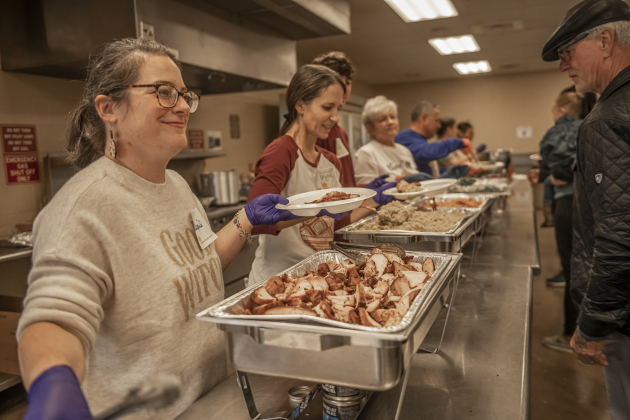 April Bennett, left, and Crystal Kruse were among the volunteers helping during the Community Thanksgiving, held Thursday, November 28, 2024 at the San Gabriel Community Center in San Gabriel Park.  200 pounds of turkey breast, combined with numerous side dishes, drinks and desserts were provided at no charge to anyone who wanted a Thanksgiving meal.  The event was conducted by members of the Georgetown Beard Club, plus the City of Georgetown police and fire departments.     Photo by Andy Sharp.