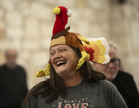 Volunteer helper Kendra Bostick wore a  festive turkey-themed hat during  the Community Thanksgiving, held Thursday, November 28, 2024 at the San Gabriel Community Center in San Gabriel Park.  200 pounds of turkey breast, combined with numerous side dishes, drinks and desserts were provided at no charge to anyone who wanted a Thanksgiving meal.  The event was conducted by members of the Georgetown Beard Club, plus the City of Georgetown police and fire departments.     Photo by Andy Sharp.