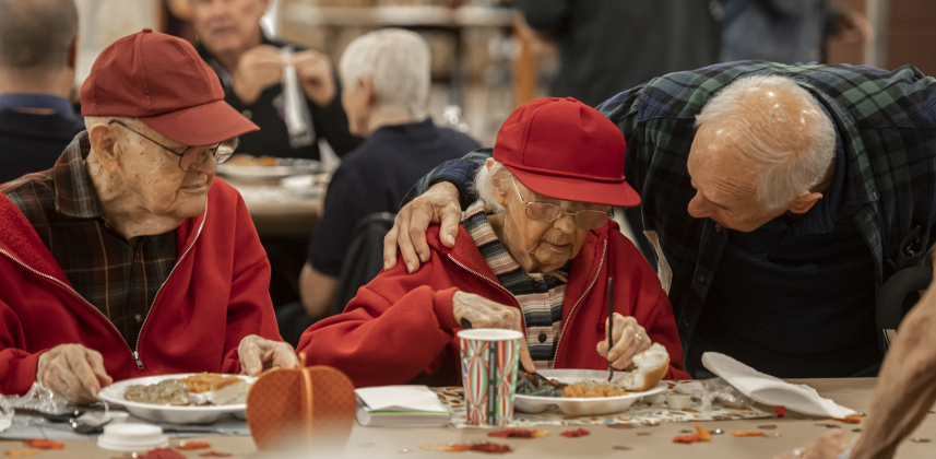 Volunteer Ron Bean, right, makes sure Joana Ayers, 92, and her husband Jerry, 91, were provided with what might be needed   during the Community Thanksgiving, held Thursday, November 28, 2024.