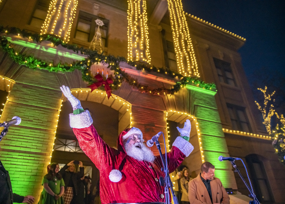 Santa Claus welcomes the light as it comes on during the annual Lighting of the Square in downtown Georgetown on  Friday, November 29, 2024. The streets and courthouse lawn were jammed with thousands of attendees on a cool autumn evening.    Photo by Andy Sharp. 