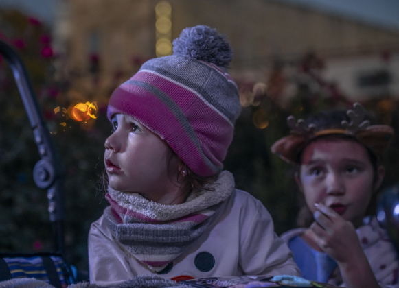 4-year-old Analise Curl, left, and her sister Katherine, 7, right, enjoyed their time at  the annual Lighting of the Square in downtown  Georgetown on  Friday, November 29, 2024. The streets and courthouse lawn were jammed with thousands of attendees on a cool autumn evening.    Photo by Andy Sharp.