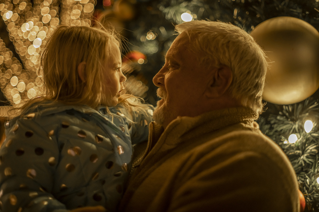 Gordon Cox spends time with granddaughter Codi Cox, 4, near the Christmas tree  during the annual Lighting of the Square in downtown Georgetown on  Friday, November 29, 2024. The streets and courthouse lawn were jammed with thousands of attendees on a cool autumn evening.    Photo by Andy Sharp.