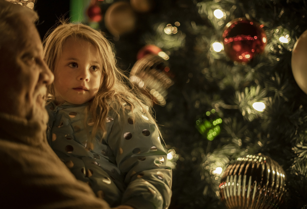 Gordon Cox spends time near the Christmas tree with granddaughter Codi Cox, 4, during the annual Lighting of the Square in downtown Georgetown on  Friday, November 29, 2024. The streets and courthouse lawn were jammed with thousands of attendees on a cool autumn evening.    Photo by Andy Sharp.