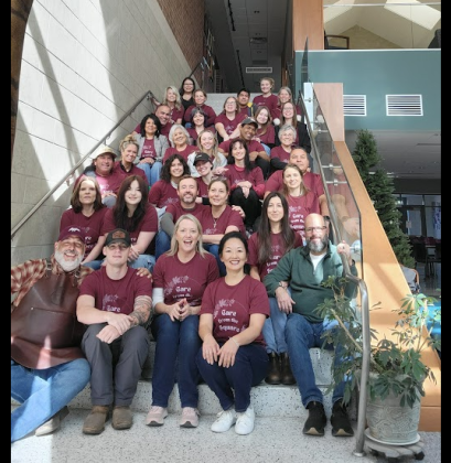 Kevin and Rachel Cummins, center, second row from the bottom, the owners of City Post and Sweet Lemon, with the volunteers who helped serve families for the event. (Courtesy Rooted Hospitality)