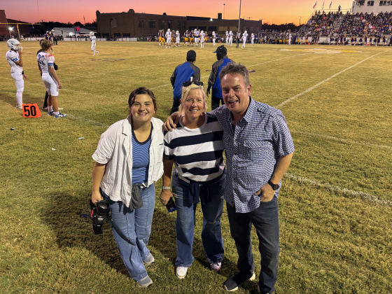 Assistant Director Maddie Abdalla, left, Producer Roxane Davis, center, and Director Ray Seggern pose during a home football game for the Bartlett Bulldogs against Granger on September 27 for the "Voice of the Bulldogs" documentary. Photo courtesy of "Voice of the Bulldogs."