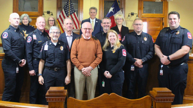Williamson County Commissioners, back row, stand with the Williamson County Emergency Medical Services leadership team, which includes original Medical Director Dr. Stephen Benold (center, tan sweater), EMS Director Mike Knipstein (behind and to the right of Mr. Benold), and prior EMS Director John Sneed (behind and to the left of Mr. Benold). Photo courtesy of Williamson County.