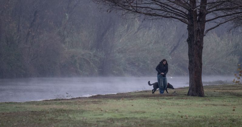 Isla Shane walks her dog Maverick in a nearly-deserted San Gabriel Park on a cold, wet and misty  Thursday, January 9, 2025.   Photo by Andy Sharp.