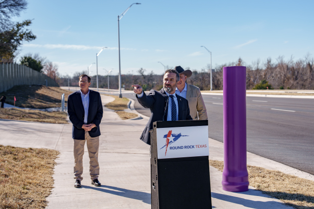 Round Rock Mayor Craig Morgan, front, gives a speech about Kenney Fort Boulevard with Public Works Director Michael Thane, left, and County Commissioner Russ Boles behind. Photo courtesy of the City of Round Rock.