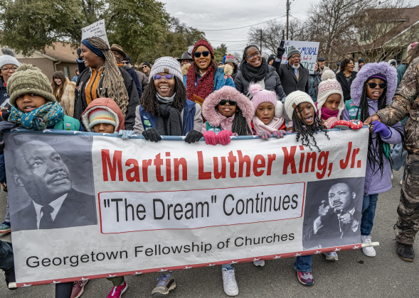 Kids from Girl Scout Troop 46105 carry a large banner along Martin Luther King Jr. Street as they participate in a march during the Dr. Martin Luther King Jr. Day march and celebration held at Macedonia Baptist Church on Monday, January 20. (Photos by Andy Sharp)