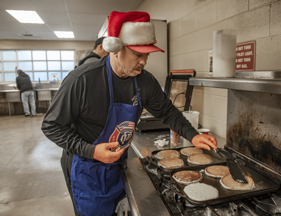 Georgetown Assistant Fire Chief Clay Shell helps grill pancakes for Breakfast With Santa, held Saturday, December 21, 2024 at the San Gabriel Community Center.  The event, coordinated by the Georgetown Fire Department and the Rotary Club of Sun City, served up pancakes, sausage, juice and coffee to attendees.  Santa Claus was there throughout the morning to visit the kids and their families.    Photo by Andy Sharp.