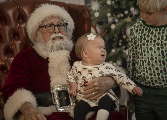 15-month-old Layla Wright was feeling a bit timid as she and her brother Hudson, 6, visited with Santa Claus during Breakfast With Santa, held Saturday, December 21, 2024 at the San Gabriel Community Center.  The event, coordinated by the Georgetown Fire Department and the Rotary Club of Sun City, served up pancakes, sausage, juice and coffee too attendees.  Santa Claus was there throughout the morning to visit the kids and their families.    Photo by Andy Sharp. 