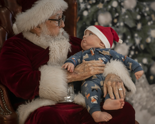7-month-old Landon Bahr, whose father is Georgetown Fire Department fireman Matt Bahr, had his first ever visit with Santa Claus during Breakfast With Santa, held Saturday, December 21, 2024 at the San Gabriel Community Center.  The event, coordinated by the Georgetown Fire Department and the Rotary Club of Sun City, served up pancakes, sausage, juice and coffee too attendees.  Santa Claus was there throughout the morning to visit the kids and their families.    Photo by Andy Sharp.