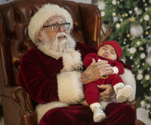 3-month-old Aziel Ruiz took a nap during a visit with Santa Claus at Breakfast With Santa, held Saturday, December 21, 2024 at the San Gabriel Community Center.  The event, coordinated by the Georgetown Fire Department and the Rotary Club of Sun City, served up pancakes, sausage, juice and coffee too attendees.  Santa Claus was there throughout the morning to visit the kids and their families.    Photo by Andy Sharp.