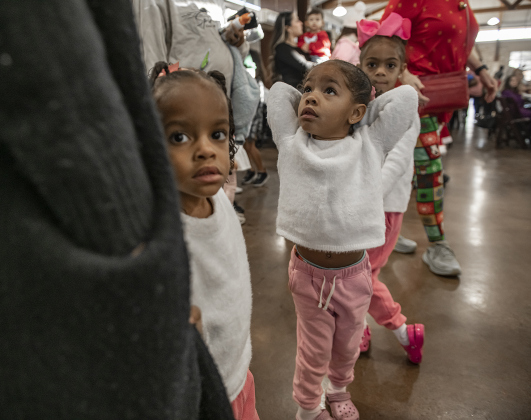 3-year-old twins Amira and Amani Penn and their sister Yanna, 5, back right, wait to visit with Santa Claus during  Breakfast With Santa, held Saturday, December 21, 2024 at the San Gabriel Community Center.  The event, coordinated by the Georgetown Fire Department and the Rotary Club of Sun City, served up pancakes, sausage, juice and coffee too attendees.  Santa Claus was there throughout the morning to visit the kids and their families.    Photo by Andy Sharp.