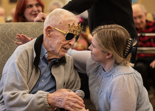 Al Blaschke spends time with Emily Hart, Activities Director at The Wesleyan Assisted Living as he celebrates his 108th birthday with a party there  on Saturday, January 4, 2025.