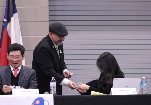 Taylor Mayor Dwayne Ariola passes out Taylor High School Duck stickers after his speech at the celebration.