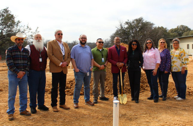 Dr. Satish Chundru, in red, breaks ground with the Williamson County Justices of the Peaces KT Musselman of Precinct 1, center left, and Rhonda Redden of Precinct 4, center right. They are joined by the newly-hired death investigators. Photo by Nalani Nuylan.