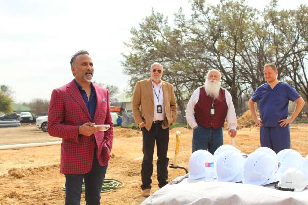 Dr. Chundru, left, gives a speech about the new Hill County Forensics facility in Georgetown, February 6. Photo by Nalani Nuylan.