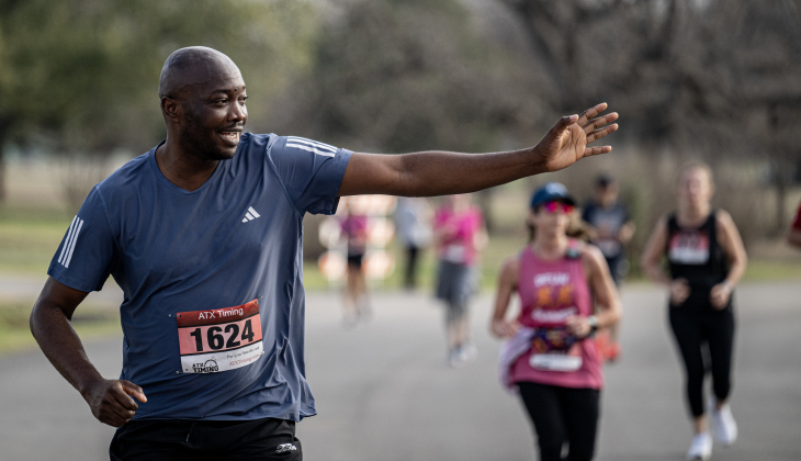 Murcellinus Ojinnaka waves to his family as he nears the completion of his 5K race  during the 30th Annual Cupid’s Chase, held in San Gabriel Park on Saturday, February 8, 2025. The event is sponsored by the Georgetown Parks Department.   Photo by Andy Sharp.   
