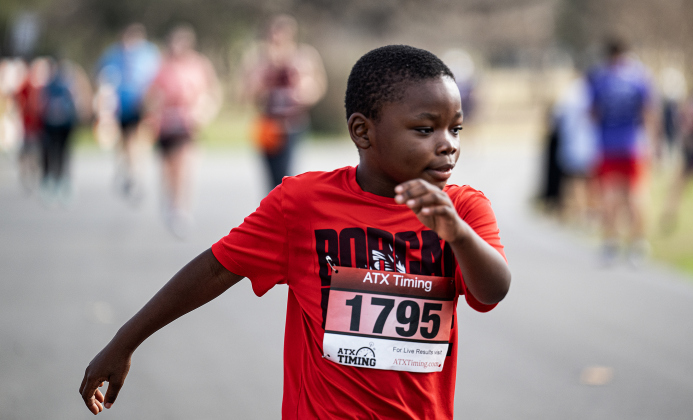 9-year-old Isaac Thornton nears the 5K run finish line during the 30th Annual Cupid’s Chase, held in San Gabriel Park on Saturday, February 8, 2025. The event is sponsored by the Georgetown Parks Department.   Photo by Andy Sharp.