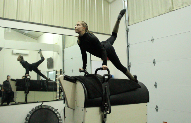 Fly High Vaulter Charlotte Kacir practices her Individual Freestyle on a vaulting barrel in the Fly High Vaulters gym.