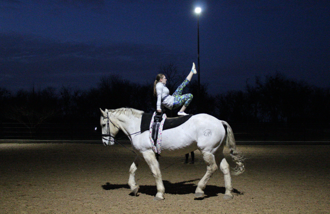 Grace Beach performs a candlestick pose on the trotter horse, Atlas in Weir during a Thursday night practice, on February 13.