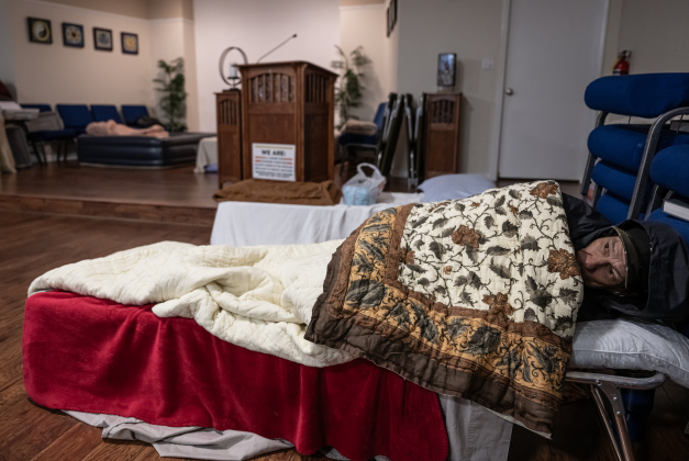 Jeffrey Jenkins finds comfort in  the warming shelter  at San Gabriel Unitarian Universalist Fellowship on Wednesday evening, February 19, 2025.