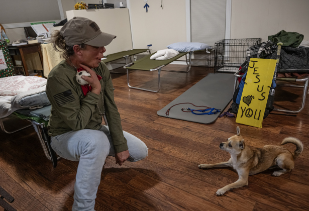 Kristina Nicol spends time with her dog named Justice as they find comfort together in  the warming shelter at San Gabriel Unitarian Universalist Fellowship on Wednesday evening, February 19, 2025.