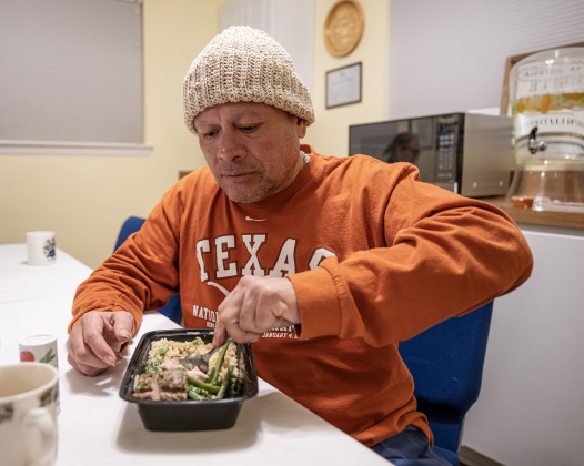 David Valdez enjoys an evening meal in the warming shelter   at San Gabriel Unitarian Universalist Fellowship on Wednesday evening, February 19, 2025.