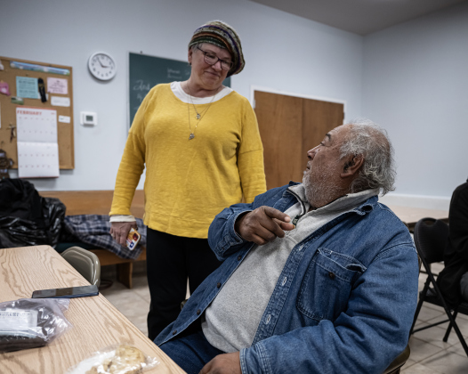 Taylor CAN member Lisa Stiles Drummond visits with Armando Robles at St. James Episcopal Church on Wednesday, February 19, 2025.  The shelter is overseen by Taylor CAN (Center for Assistance and Navigation).