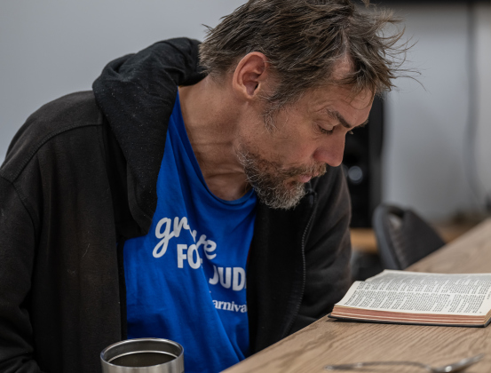 Michael Joseph Mann reads from the Bible while being in a warm place  at St. James Episcopal Church on Wednesday, February 19, 2025.