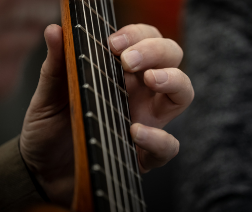 Kevin Taylor (pictured) fingers the frets as he and Gabriela Bravo perform during a Williamson County Guitar Society meet and greet.