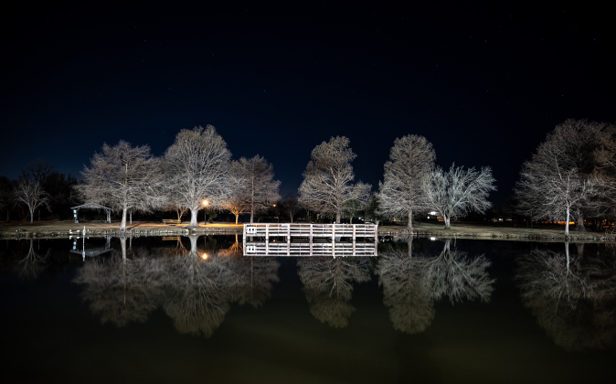 Taylor's Bull Branch Park is seen in the early-evening hours  on Friday, January 24, 2025, about an hour after sunset.  Bull Branch Creek flows through the park, at one point offering a pond before proceeding to Murphy Park and beyond.  Cypress trees have taken on their winter look for a while.    Photo by Andy Sharp.  