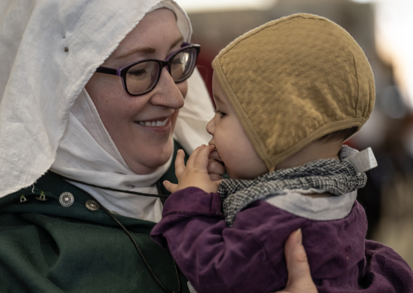 Ashley Stillwell-Hasan and her 8-month-old son Yusuf spend time together at the Society for Creative Anachronism Bryn Gwald Candlemas, held Saturday, February 1, 2025.