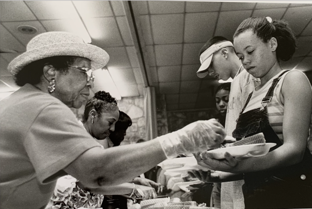 Beatrice Miller of the GCCMA serves Shymetria Anderson at a past Juneteenth event. (Sun Archive)