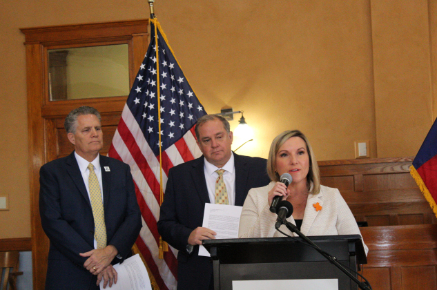 Hutto ISD Superintendent Jeni Neatherlin, right, explains how Hutto ISD will be impacted by the tax exceptions from Cameron County Housing Finance Corporation purchasing properties in Williamson County, March 5. She is accompanied by County Judge Bill Gravell, left, and County Commissioner Russ Boles, center. Photo by Nalani Nuylan.