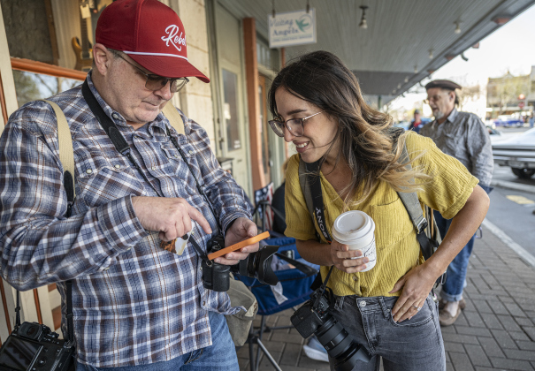 John Fought and Marcela Briere share social media contact information during the Texas Photography Festival on Saturday, March 15, 2025.  Briere is a landscape photographer who conducted one of the festival workshops.