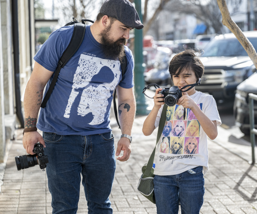 Jim Rollins and his son Wyatt, 9, seen along 8th Street,  each brought their cameras  the Texas Photography Festival on Saturday, March 15, 2025.