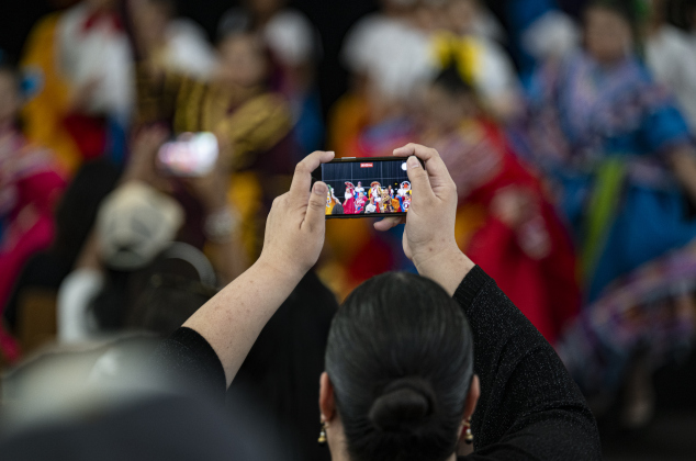 Christina Calixtro photographs a performance by the Ballet Folklorico Company.